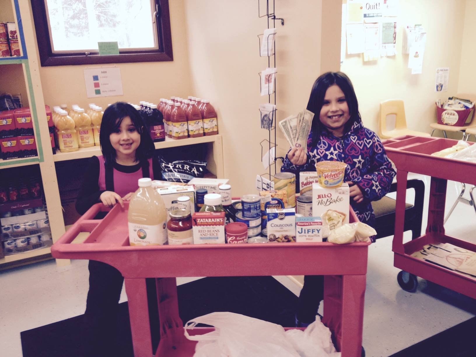 Two girls posing with their donations